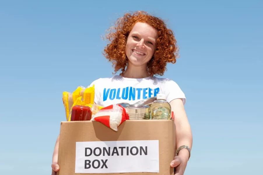 Volunteer holding donation box